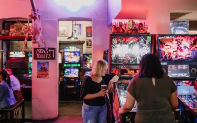 Two females playing arcade games in Netherworld