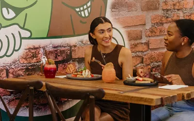 Two females enjoying breakfast and juices at Bare Beanz Cafe