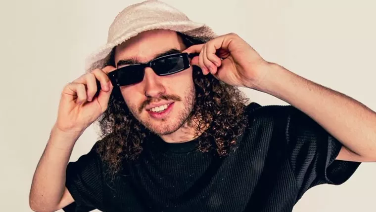 person in black t shirt with hands holding sunglass frames