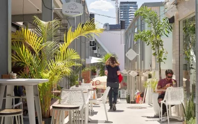 person standing and other sitting in California Lane