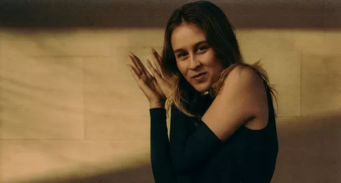 female at an angle clapping hands