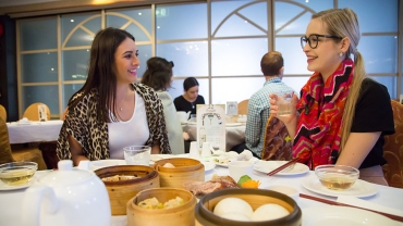 Two women sitting at dumpling restaurant