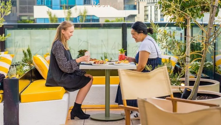 Rooftop dining on yellow bench seats