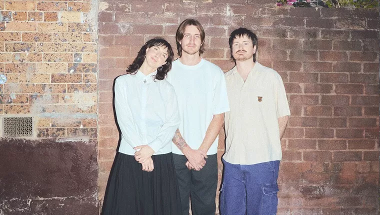 3 band members of Jet City Sports Club standing infront of brick wall